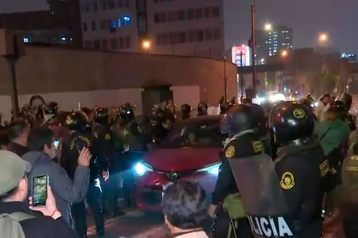 Joven inconsciente es cargado por policía y trasladado en vehículo durante marcha